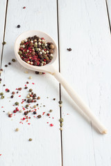 a mixture of peppers on a wooden spoon
