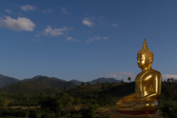 Statue de Bouddha en or avec montagne en arrière-plan