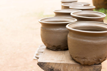 drying earthenware on wooden shelf