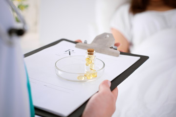 Fototapeta premium Close-up of a female doctor while offering pills to patient. Health care concept