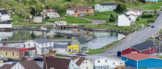 Small village and community buildings in Twillingate, Newfoundland.  Homes along shoreline in this...