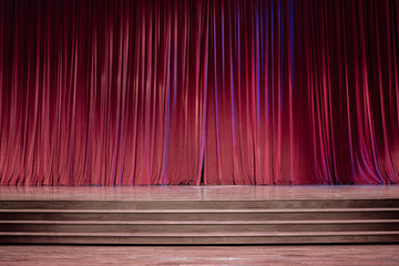 Old red curtains on stage.