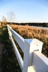 white picket fence by the lake