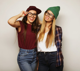  Two young girl friends standing together and having fun