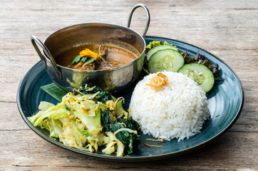 Tyical Indonesian dish: Rendang beef served with vegetables and rice