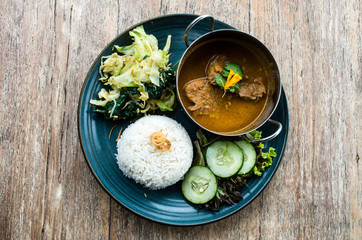 Tyical Indonesian dish: Rendang beef served with vegetables and rice