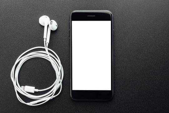 Black Phone White Screen And Headphone On Black Background.jpg