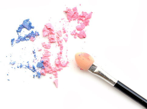crushed pastel tone eyeshadows with brush isolated on white background