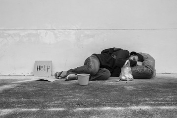 Homeless person sleep on sidewalk of the street 