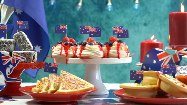 Australian theme party table with flags and iconic food including mini pavlovas, lamingtons, meat pies and fairy bread, full table dolly pan.