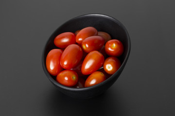 tomatoes in black bowl