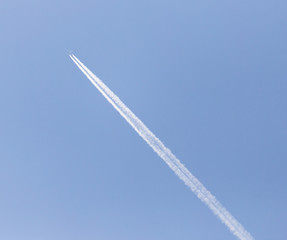trace of an airplane against blue sky