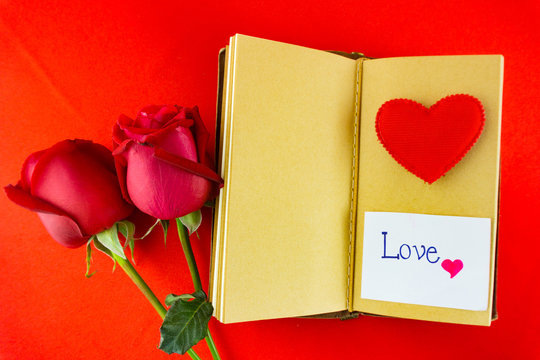 Valentines notebook with message card on red background Image of