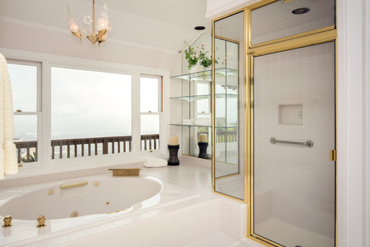 Bathroom with large bath-tub and Gold appliances