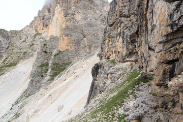 People climbing the Via Ferrata Severino Casara in Sexten Dolomites with mountain panorama, South Tyrol, Italy