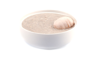 Cream soup with mushrooms on a white background