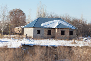 unfinished brick house in winter