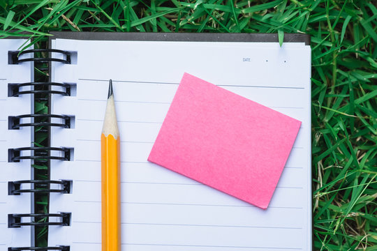 To do list notebook in green grass - Powered by Adobe