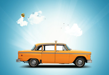 Taxi, retro car orange color on the sky background