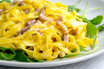 tasty pasta with roast ham on the table