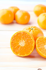 Fresh oranges cut on wooden background