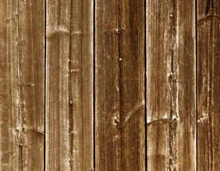 Weathered orange wooden fence texture with nails.