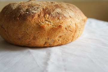 Round bread on white tablecloth