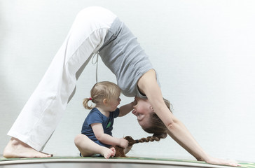 Naklejka premium Hatha yoga fitness mother with baby.