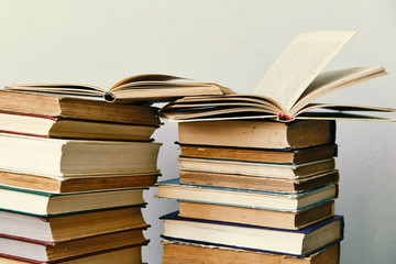 pile of old books and an open book  in hardcover