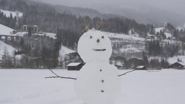 Snowman in alpine style in snowfall