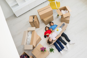 Happy kids with boxes at new modern home
