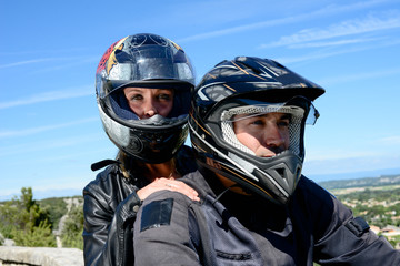 happy young biker couple riding their motorbike in summer