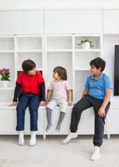 Happy children having fun and posing in new modern home