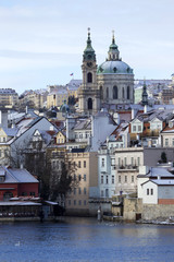 Christmas romantic snowy Prague City with St. Nicholas' Cathedral , Czech Republic
