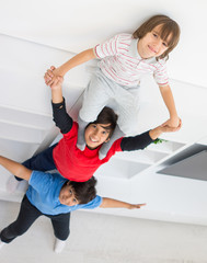 Fototapeta premium Cheerful funny children having fun and posing line up piggyback