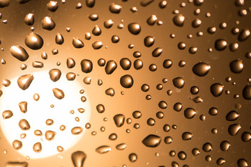 Water drops on the glass at sunset