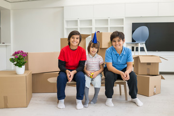 Fototapeta na wymiar Happy kids with boxes at new modern home
