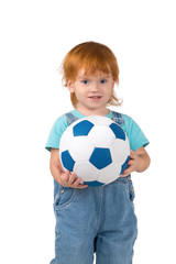 the child with red-hair holds a soccerball in hand