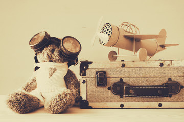 Photo of vintage toy plane and cute teddy bear
