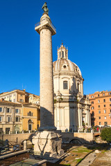 Fototapeta premium Rome, Italy. Ruins of the Trajan's Forum: Column of Trajan (113) and the Church of the Holy Name of Mary (1736 - 1738)