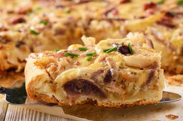 Homemade savory pie with onion, cheese and bacon.