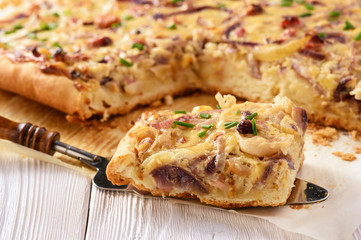 Homemade savory pie with onion, cheese and bacon.