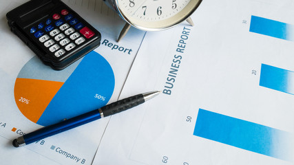business report or Financial paper with pen and calculator in bu