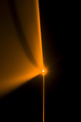 Fototapeta na wymiar Laser beam orange on a black background