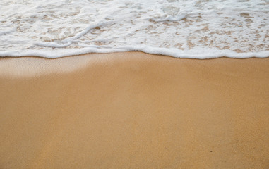 Fototapeta na wymiar Bubbles waves on the beach texture background