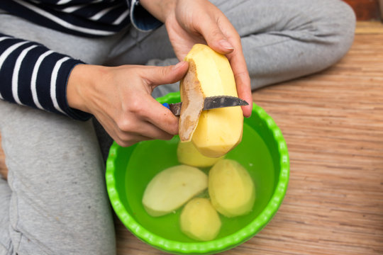woman peeling potatoes