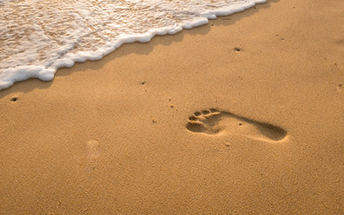Bubbles waves and foot print on the beach  background.