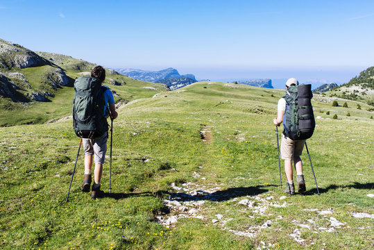 Two teenager starting an hiking tour in the french alps