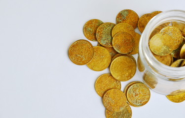 gold coin in glass bottle on white background