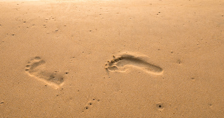 Bubbles waves and foot print on the beach  background.